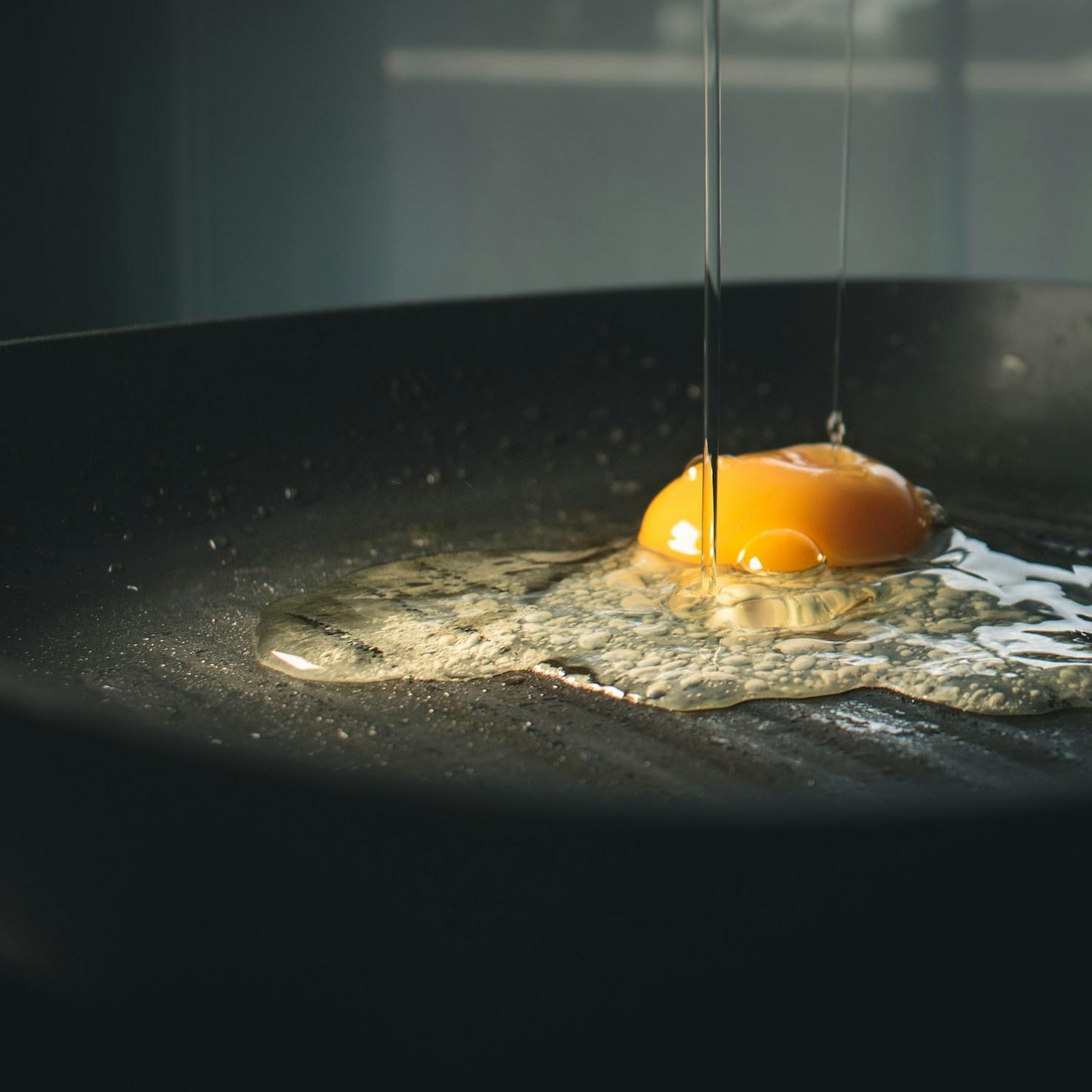Diverse group of community members sharing a meal together, showcasing the social bonds formed through collaborative cooking